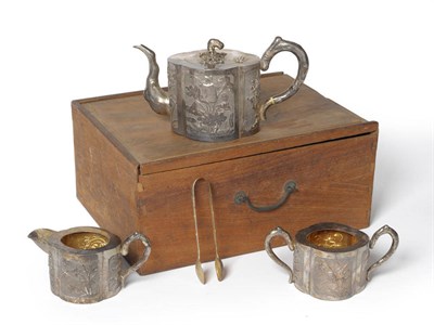 Lot 261 - A Chinese White Metal Three Piece Teaset, Keicheung, Canton, circa 1890-1900, the quatrefoil...