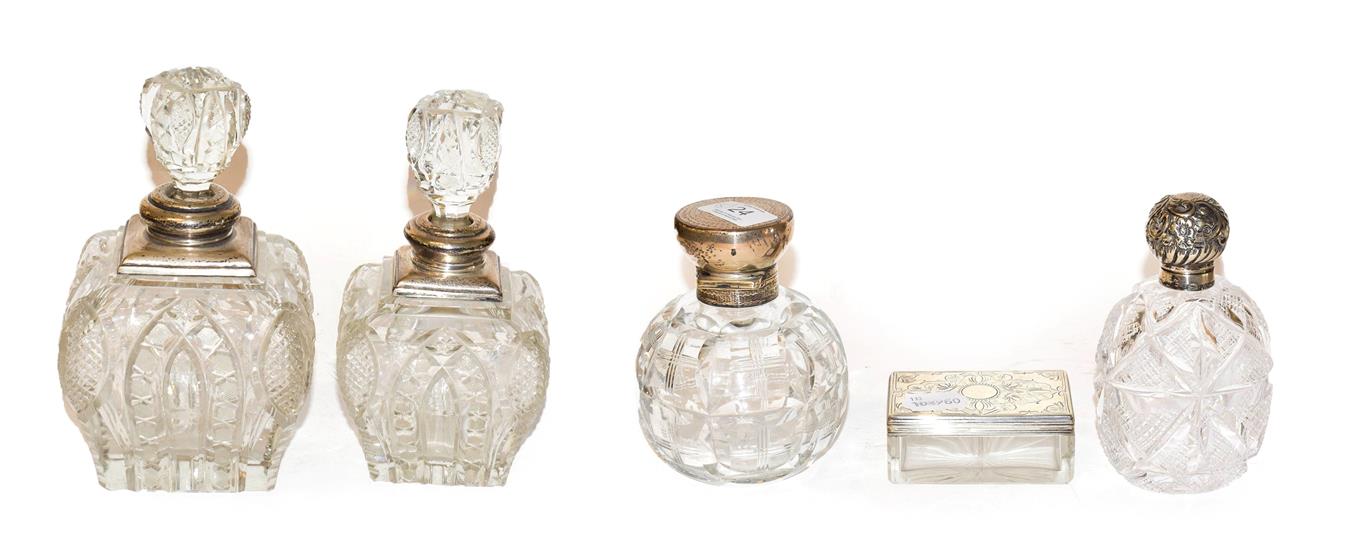 Lot 24 - Four George V cut glass scent bottles with silver mounts, together with a Victorian cut glass...
