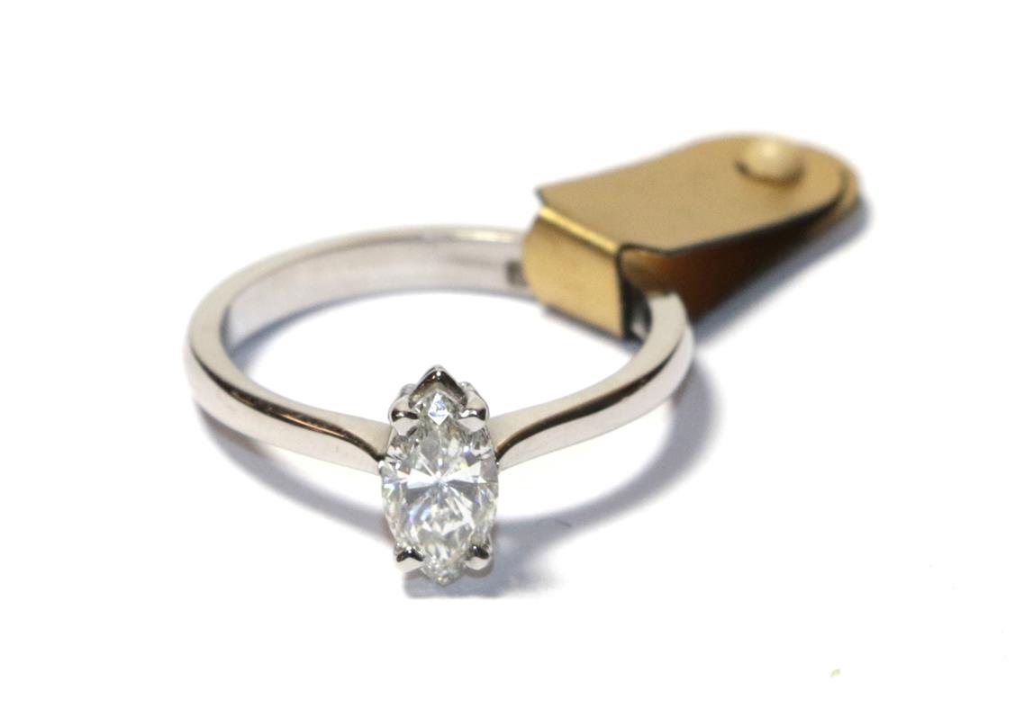 Lot 69 - A diamond solitaire ring, the marquise cut diamond in a white claw setting, to a tapered...