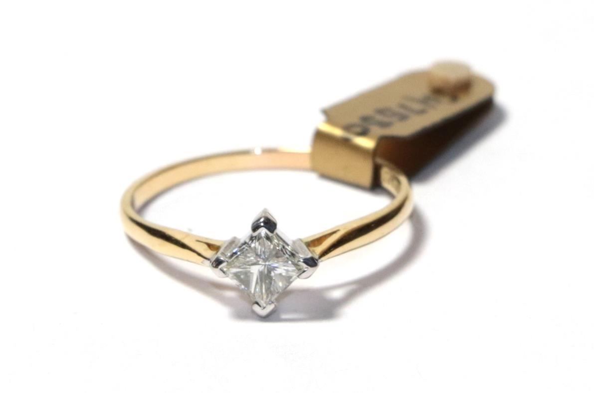 Lot 70 - A diamond solitaire ring, the princess cut diamond in a white four claw setting, to a yellow...