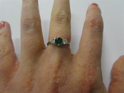 Lot 73 - An emerald and diamond three stone ring, the asscher cut emerald flanked by round brilliant cut...