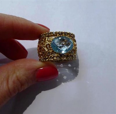 Lot 86 - A blue topaz and diamond ring, unmarked, finger size Q