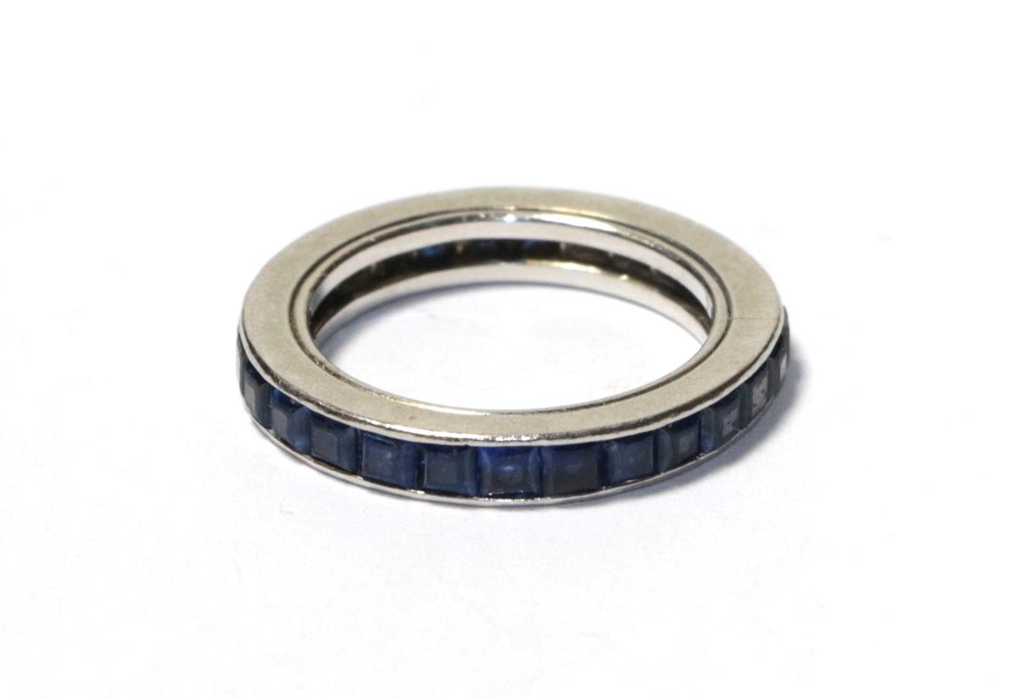 Lot 87 - A sapphire eternity ring, the calibré cut sapphires in a white channel setting, finger size I