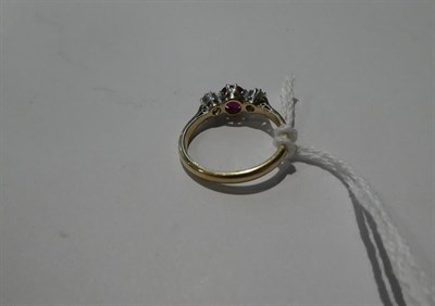 Lot 88 - A ruby and diamond three stone ring, the round cut ruby flanked by round brilliant cut diamonds...