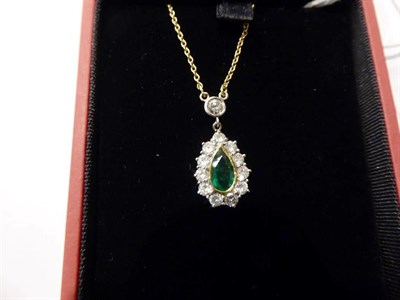Lot 89 - An 18 carat gold emerald and diamond cluster necklace, the pear cut emerald in a yellow rubbed over