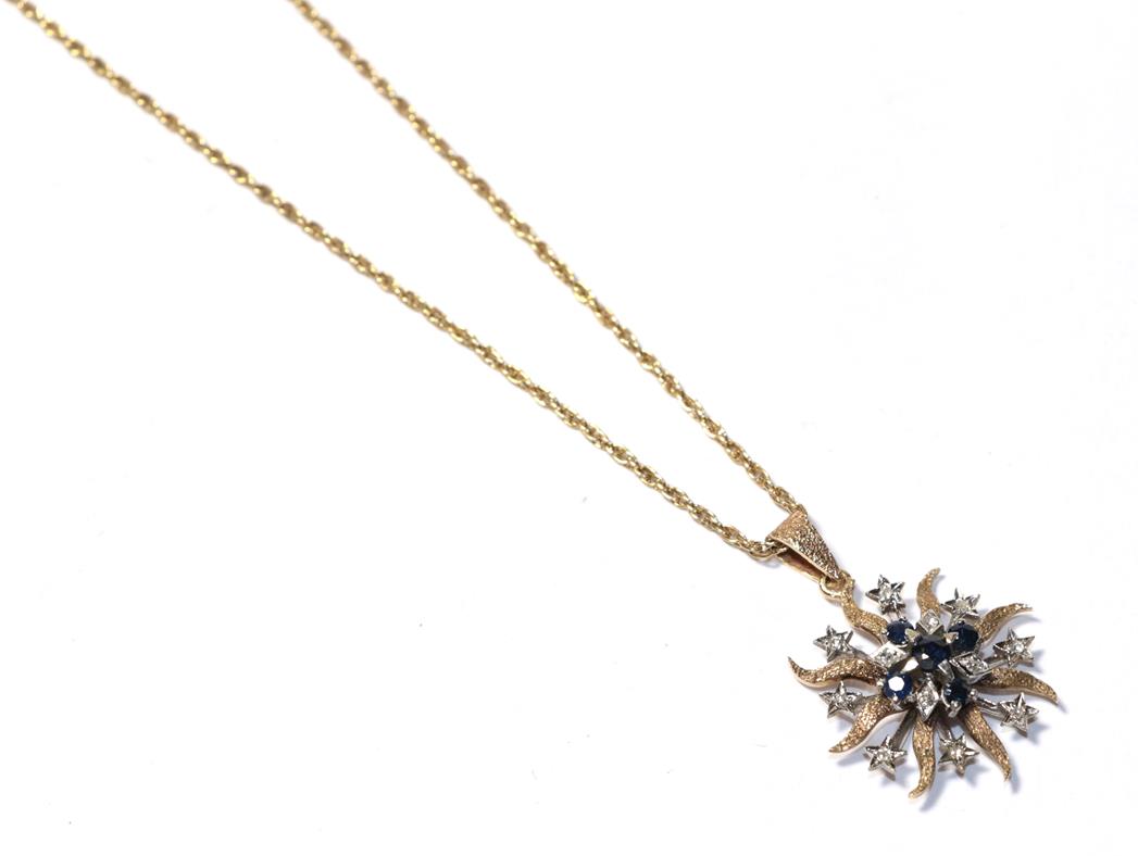 Lot 94 - A sapphire and diamond pendant on chain, the starburst motif set throughout with round cut...