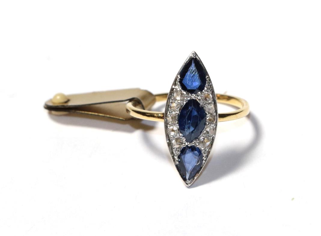 Lot 98 - A sapphire and diamond ring, the navette shape formed of an oval sapphire and two pear cut...