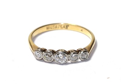 Lot 100 - A diamond five stone ring, the old cut diamonds in white rubbed over settings, to a yellow...
