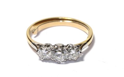 Lot 101 - A diamond three stone ring, the graduated round brilliant cut diamonds in white claw settings, to a