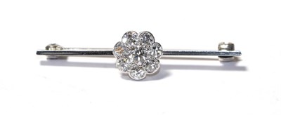 Lot 103 - A diamond cluster brooch, the round brilliant cut diamond within a border of smaller round...
