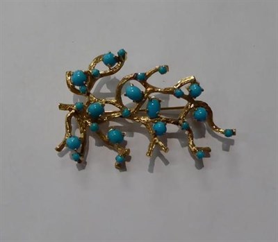 Lot 104 - An abstract brooch, set throughout with blue stones, unmarked, length 6.3cm