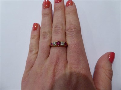 Lot 112 - A synthetic ruby and diamond five stone ring, three graduated round cut synthetic rubies...