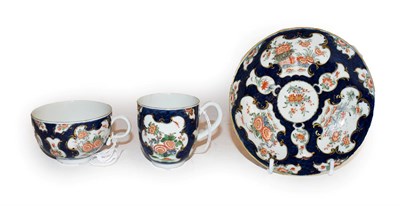 Lot 131 - A Worcester porcelain trio, circa 1770, painted with the Queen's Japan pattern on a blue scale...