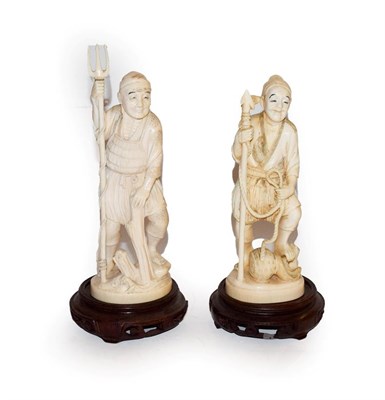 Lot 135 - Two Japanese Meiji period carved ivory okimonos on hardwood stands, each formed as a fisherman,...