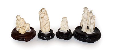 Lot 138 - Four Japanese Meiji period ivory carvings on wooden plinths, one a netsuke formed as a boy and pig