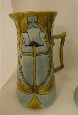 Lot 166 - A pair of Minton Secessionist No.13 jugs, with tube lined stylised decoration in green,...
