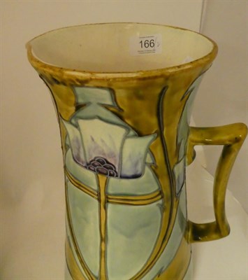 Lot 166 - A pair of Minton Secessionist No.13 jugs, with tube lined stylised decoration in green,...
