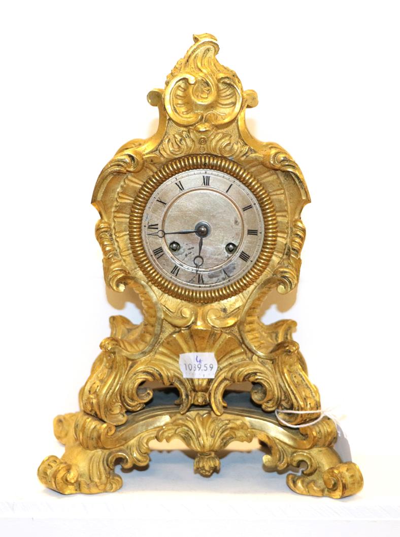 Lot 181 - A 19th century French gilt bronze mantel clock in the Rococo style, with silvered dial and...