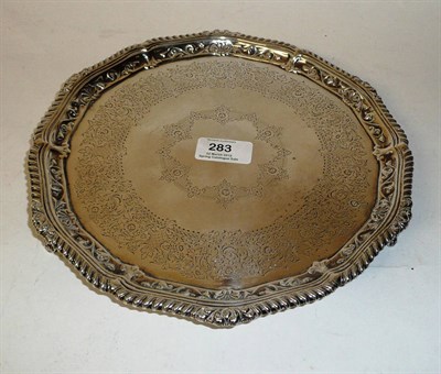 Lot 283 - An Edward VII Salver, Jackson & Fullerton, London 1904, shaped circular on three foliate cast...