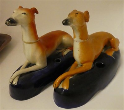 Lot 197 - A 19th century pearl ware figure of a recumbent hound, a similar Staffordshire porcelain figure and
