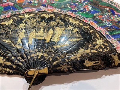 Lot 199 - Two Chinese fans in lacquered cases decorated in gilt with figures in landscape settings, the...