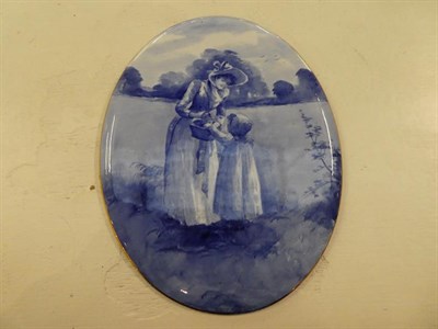 Lot 202 - Three late 19th/early 20th century large oval pottery wall plaques, decorated with figures in...