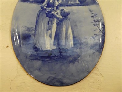 Lot 202 - Three late 19th/early 20th century large oval pottery wall plaques, decorated with figures in...