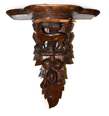 Lot 207 - An Edwardian carved oak wall bracket, surmounted by a stag and decorated with leaves, 48cm by...