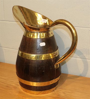Lot 244 - A coppered oak jug with brass mounts, 51cm