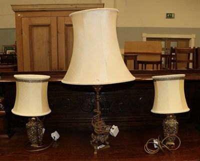 Lot 249 - A Classical style gilt metal based table lamp raised on three paw feet, together with a pair of...