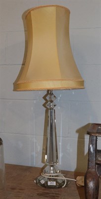 Lot 251 - A modern glass based table lamp raised on a faceted plinth, pedestal 55cm