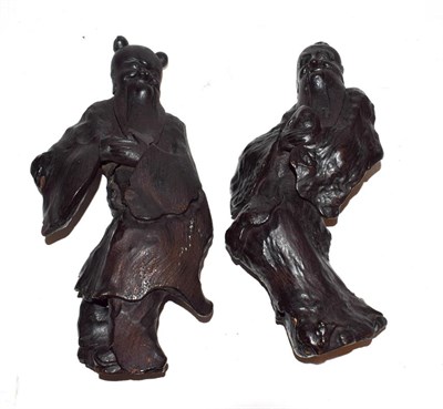 Lot 266 - A pair of 19th century Chinese root wood carvings formed as immortals, 24cm (2)