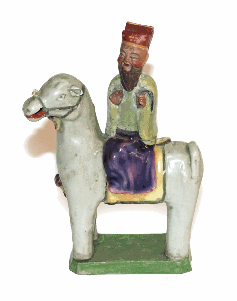 Lot 271 - A Chinese porcelain figure of a sage, Qing dynasty, possibly 18th century, on horseback, on a...