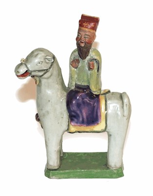 Lot 271 - A Chinese porcelain figure of a sage, Qing dynasty, possibly 18th century, on horseback, on a...