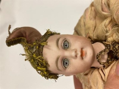 Lot 1135 - Squat bisque head Automata doll, with fixed blue eyes, closed mouth, marks indistinct '412'?,...