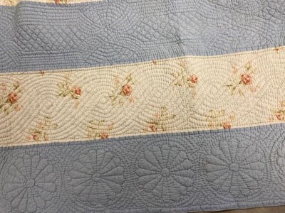 Lot 1177 - A late 19th century stripy quilt comprising pale blue and floral stripes to one side, yellow...