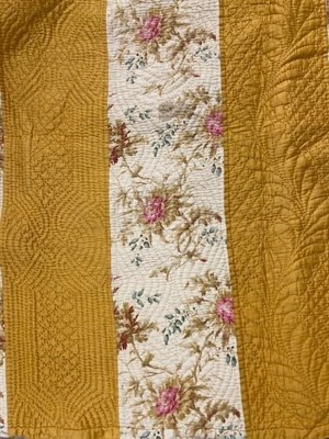 Lot 1177 - A late 19th century stripy quilt comprising pale blue and floral stripes to one side, yellow...
