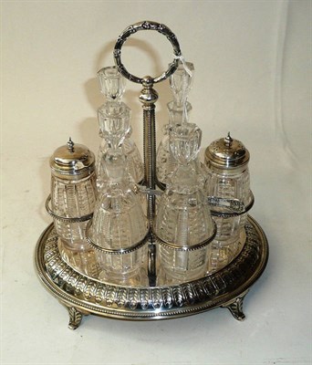 Lot 304 - A Victorian Six Bottle Cruet, Horace Woodward & Co, 1876, with laurel wreath ring handle,...