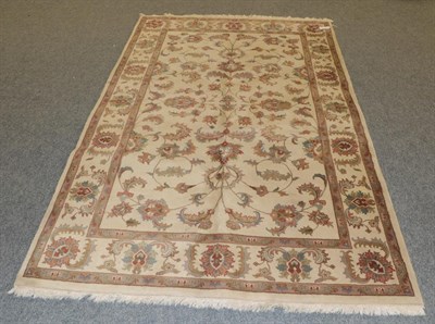 Lot 1251 - Agra design Rug, the ivory field of vines enclosed by similar borders, 240cm by 152cm