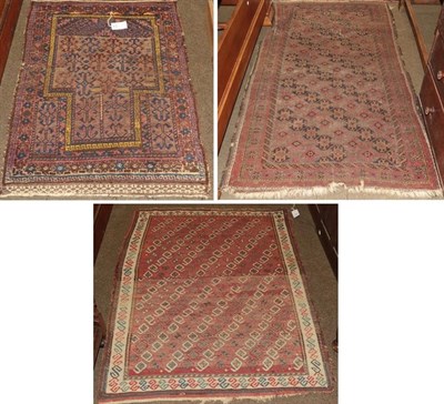 Lot 1259 - Baluch prayer rug, the field with hooked devices beneath the mihrab enclosed by stellar motif...