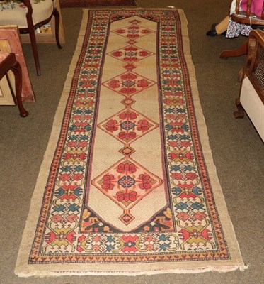 Lot 1267 - Sarak runner, the camel lattice field with rows of medallions enclosed by hashang borders 336cm...