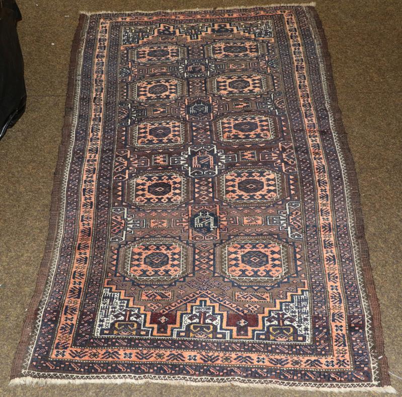 Lot 1270 - Baluch Rug, North East Iran, circa 1900 The chocolate brown field with two columns of Salor...