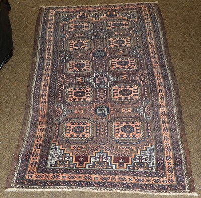 Lot 1270 - Baluch Rug, North East Iran, circa 1900 The chocolate brown field with two columns of Salor...