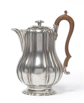 Lot 309 - A George IV Hot Water Jug, Robert Garrard, London 1825, of lobed baluster form with high scroll...