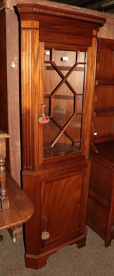 Lot 1284 - A reproduction mahogany standing corner cabinet with astragal glazed top section, 184cm