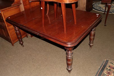 Lot 1290 - A Victorian mahogany wind out dining table with one additional leaf, raised on turned supports,...
