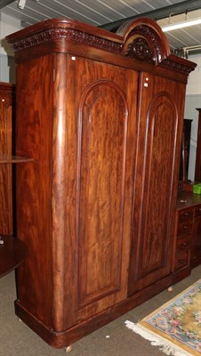 Lot 1293 - A Victorian mahogany double wardrobe with carved arch top pediment and fitted interior, 140cm...