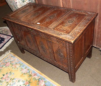 Lot 1295 - A 19th century carved oak four panel coffer, 117cm by 55cm by 74cm