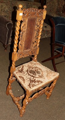 Lot 1303 - A 17th century style hall chair with carved top rail, cane back and seat