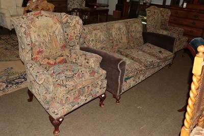 Lot 1304 - A Queen Anne style carved walnut upholstered three part suite, comprising a three seater settee and